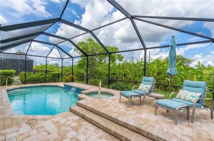 View of pool with a patio, an in ground hot tub, and a lanai