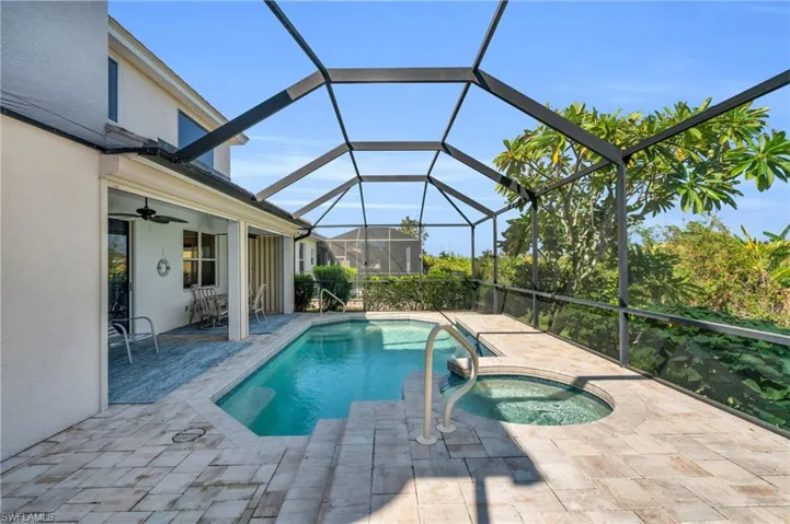 View of pool featuring an in ground hot tub, a lanai, ceiling fan, and a patio area