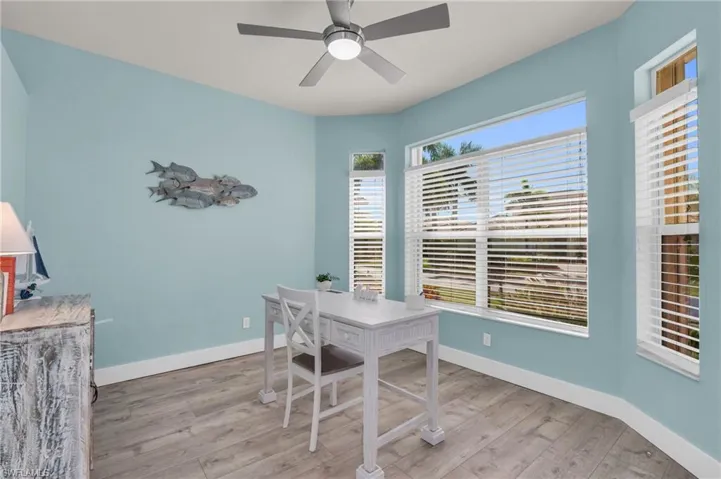 Home office featuring light hardwood / wood-style flooring and ceiling fan