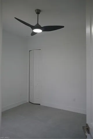 Unfurnished room featuring a ceiling fan and light tile patterned flooring