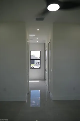 Hallway featuring baseboards and recessed lighting