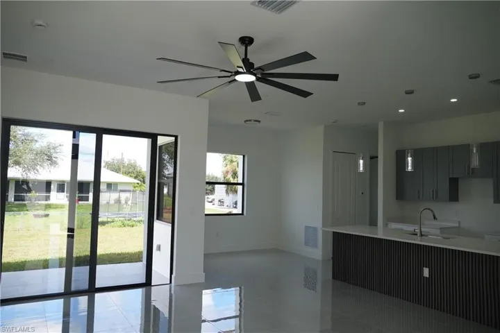 Entryway with a ceiling fan, recessed lighting, and tile patterned flooring