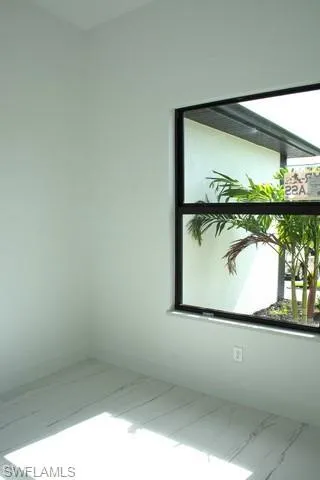 Spare room featuring a healthy amount of sunlight