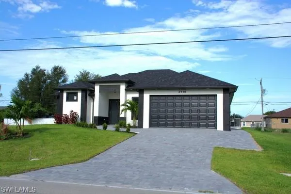 View of front of home featuring a garage and a front yard