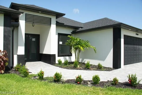 View of exterior entry with a garage