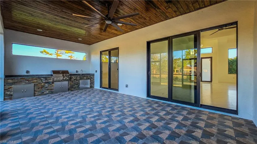 View of patio featuring a ceiling fan and exterior kitchen