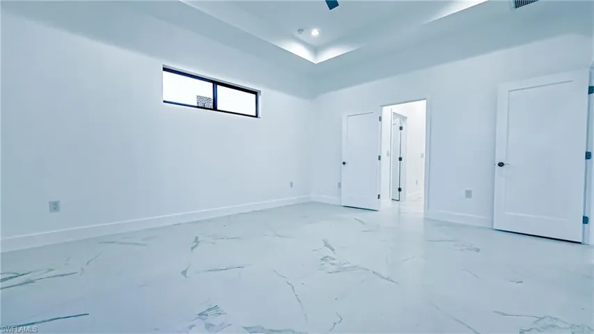Unfurnished bedroom featuring baseboards and ceiling fan