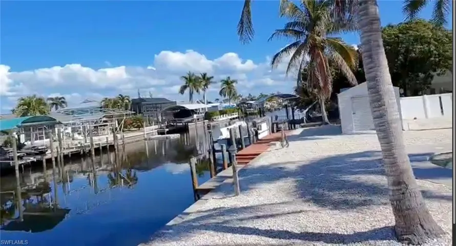 Dock area featuring a water view and boat lift