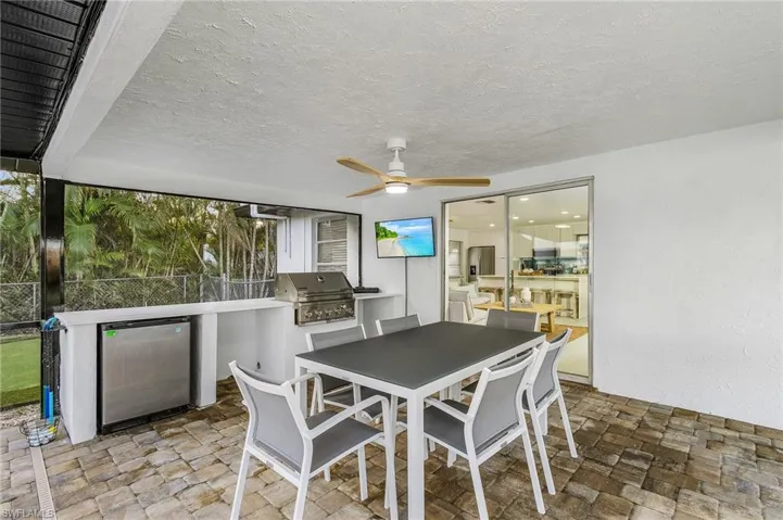 Dining space featuring stone finish flooring, a ceiling fan, and a textured ceiling