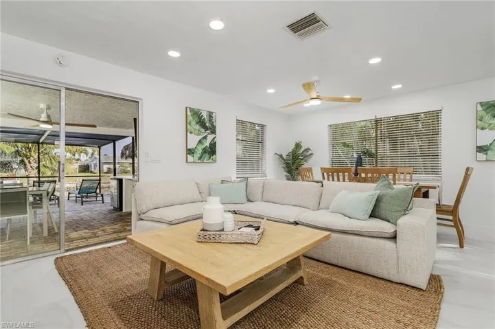 Living room featuring ceiling fan, recessed lighting, and plenty of natural light