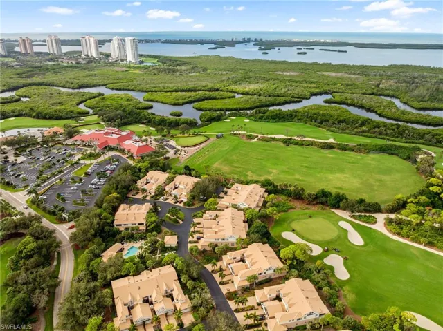 Aerial view of residential area with a large body of water and a golf course