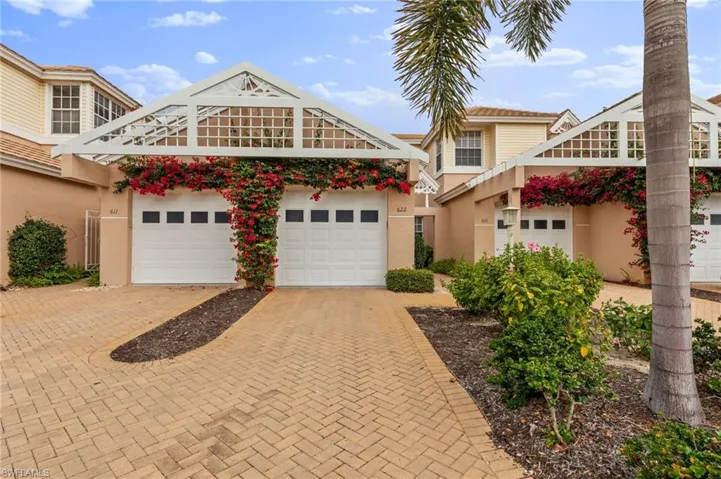 View of front of property featuring decorative driveway, stucco siding, and a garage