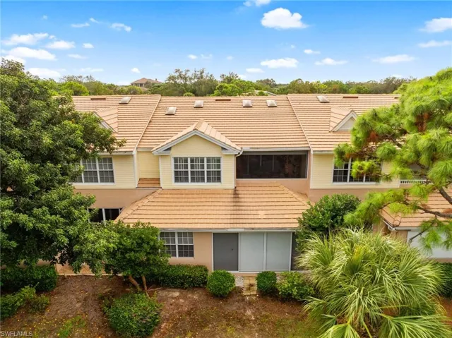 Back of property featuring a tiled roof
