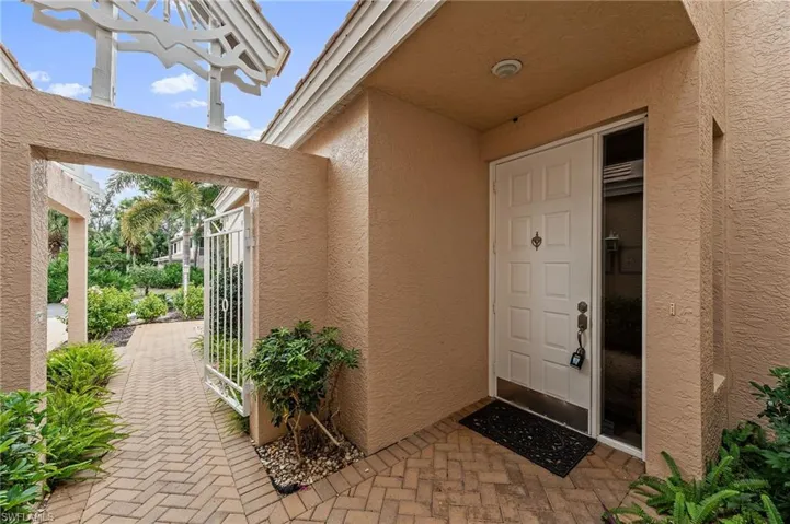 Property entrance featuring stucco siding