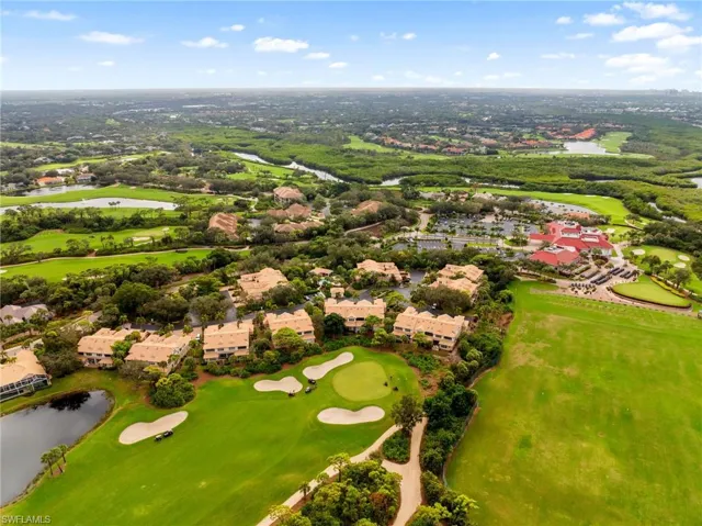 Aerial view of residential area with a large body of water and a golf course