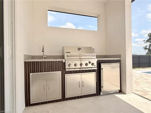 View of patio / terrace featuring a grill and a sink