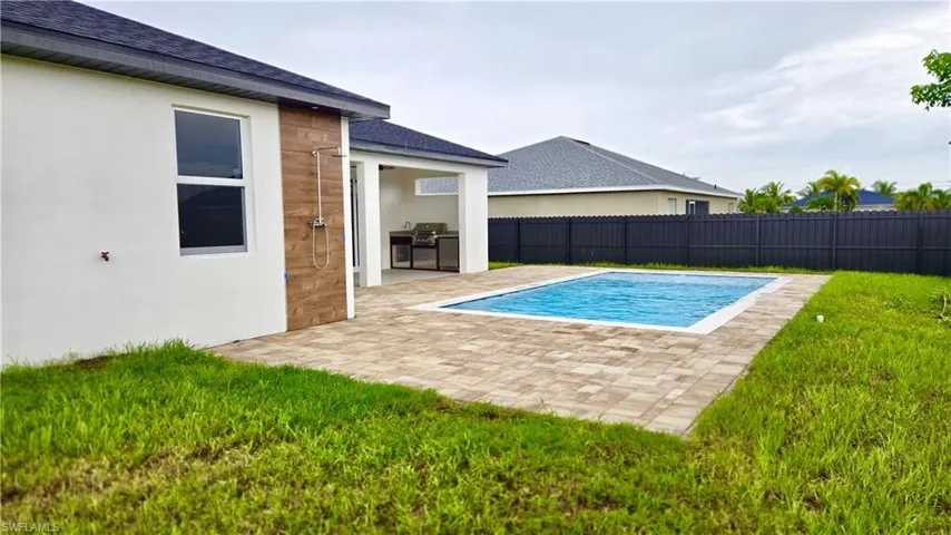 View of pool with a fenced backyard and a patio