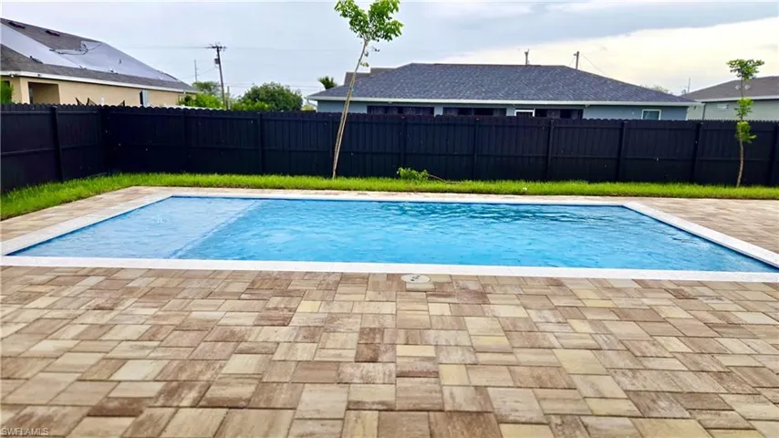 View of pool featuring a fenced backyard and a patio area