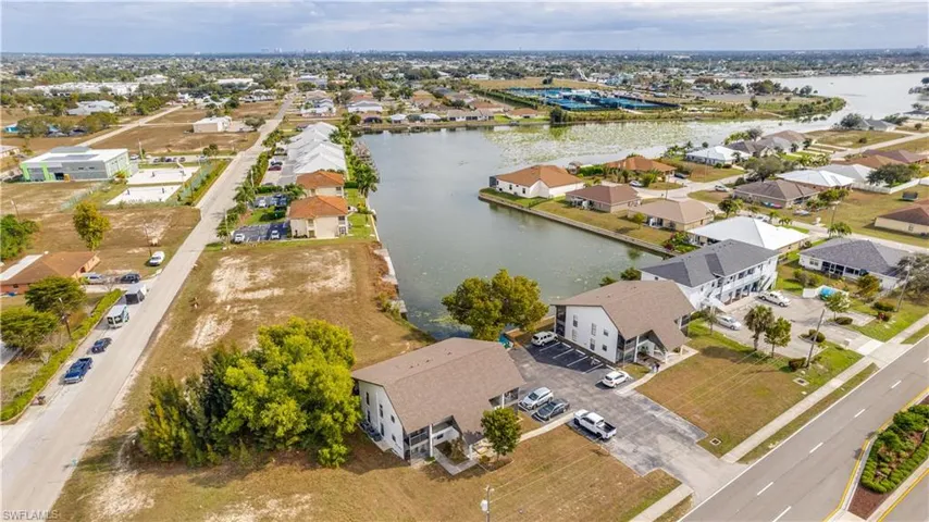 Aerial perspective of suburban area with a nearby body of water
