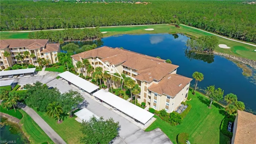 Drone / aerial view of a nearby body of water and a golf course