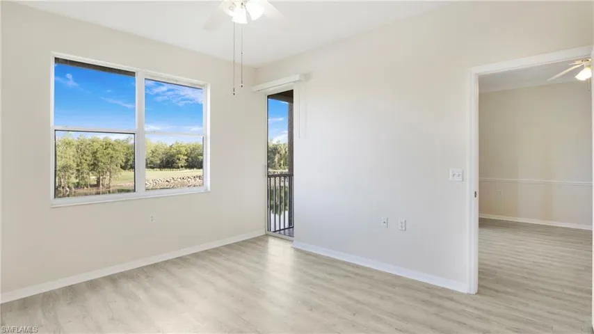 Empty room with ceiling fan and wood finished floors