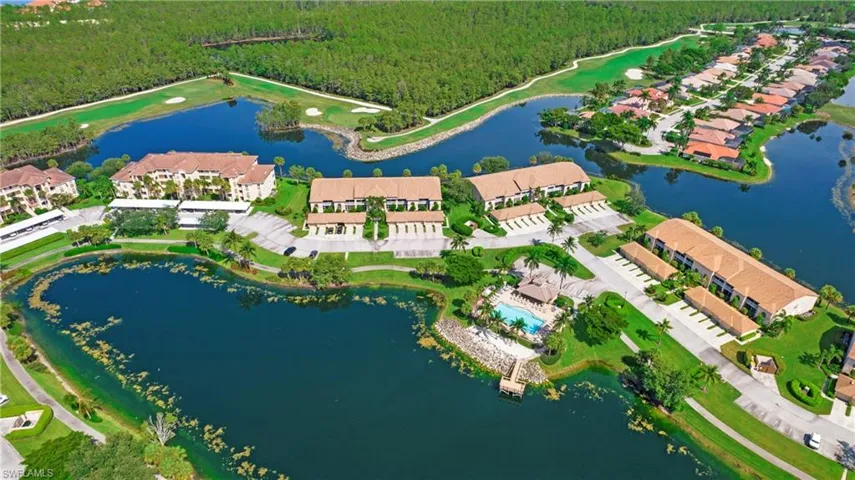 Aerial overview of property's location featuring a forest and a nearby body of water