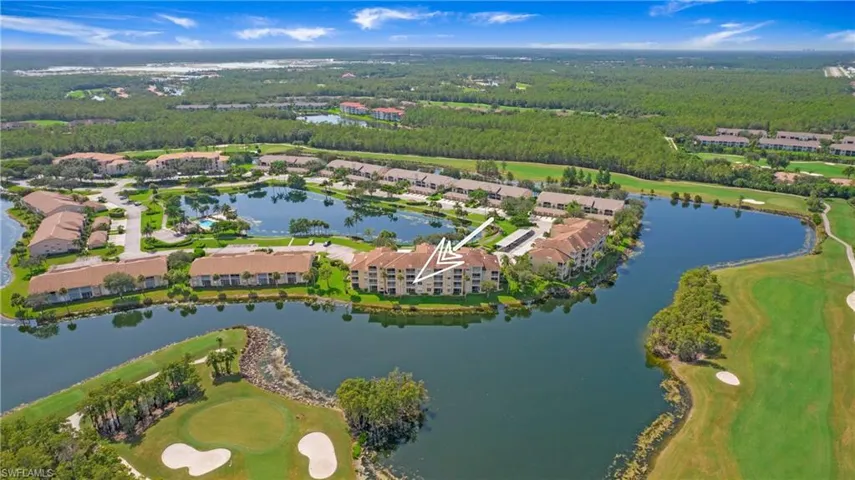 Aerial view of property's location with a local golf course and a large body of water