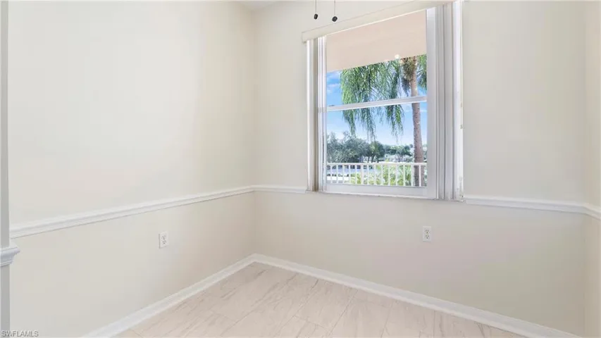 Unfurnished room featuring baseboards
