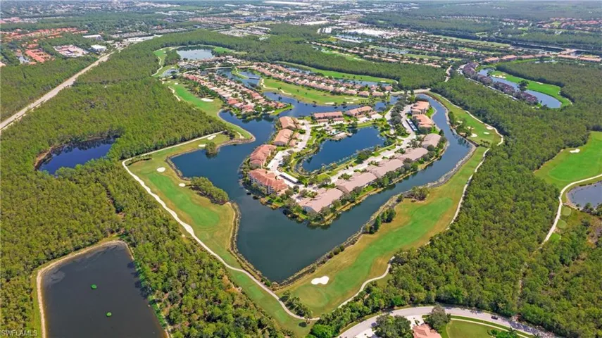 Aerial view of property and surrounding area featuring a large body of water and a golf club