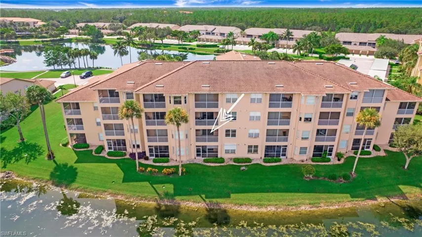 Aerial view of a large body of water and apartment complex / building