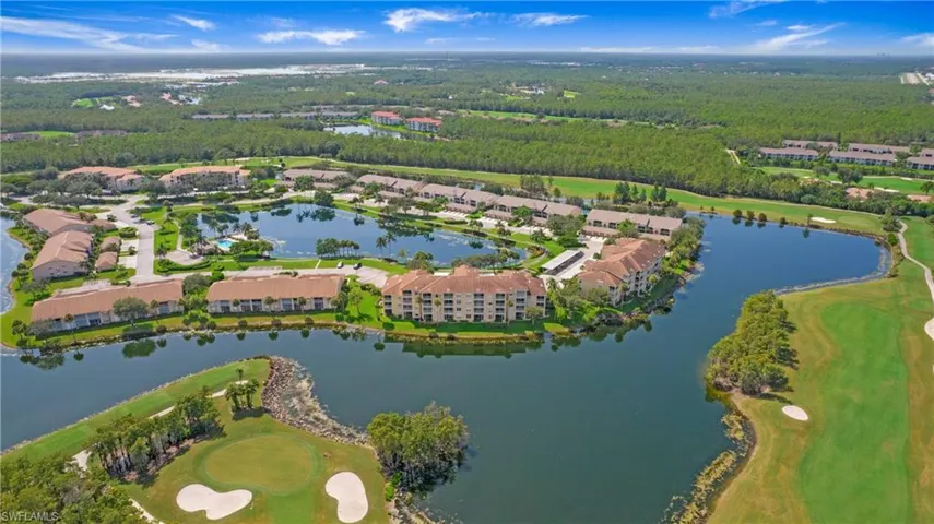 Aerial overview of property's location featuring a local golf course and a large body of water