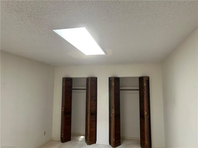 Primary suite has his & hers closets, bright happy skylight!