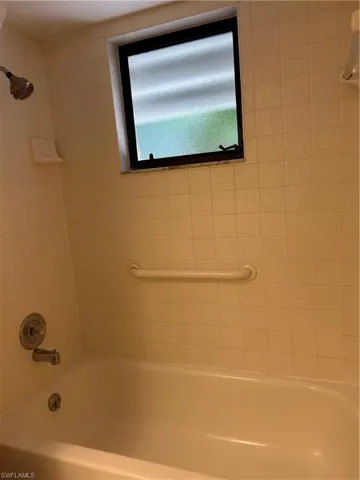 Guest bathroom tiled shower / bathtub