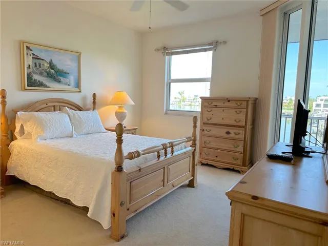 Large Master bedroom with view of bay and sliders opening out to lanai.