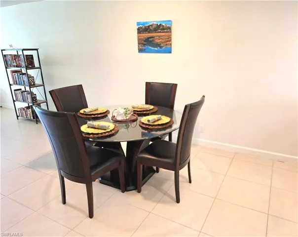 Dining area with light tile patterned floors