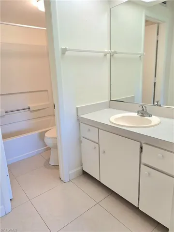 Full bathroom with shower / bathtub combination, tile patterned floors, vanity