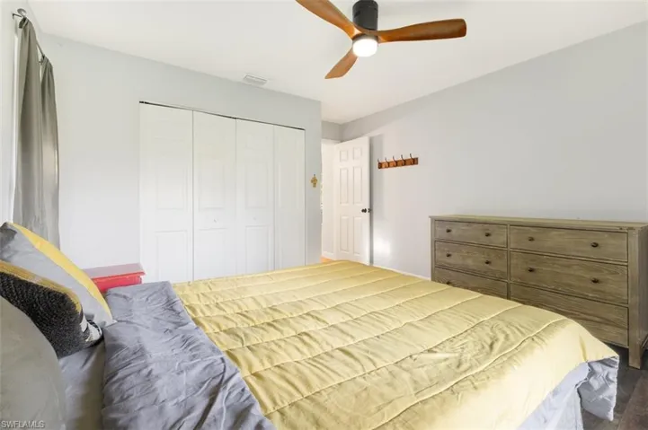 Bedroom with a closet, a ceiling fan, and wood finished floors