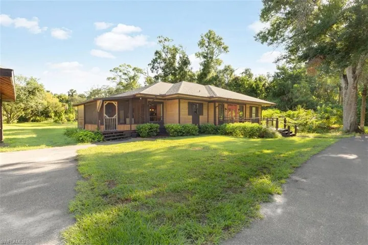 View of front of home featuring a front yard and a sunroom