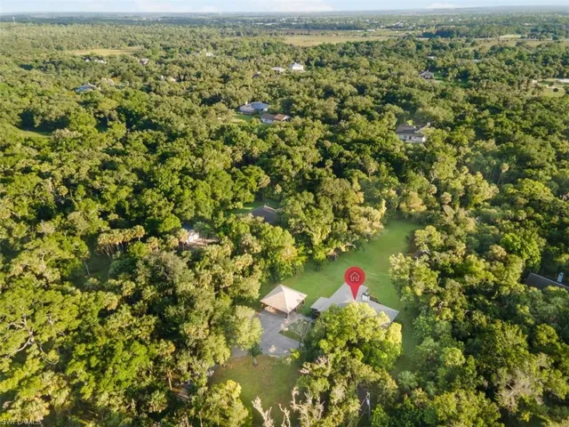 Aerial view of property's location featuring a heavily wooded area
