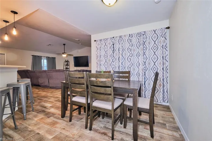 Dining area featuring vaulted ceiling and ceiling fan