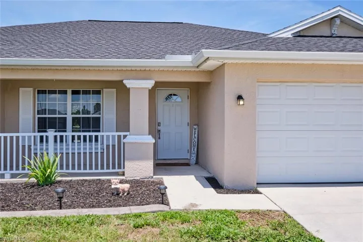 View of front of house featuring a garage and covered porch