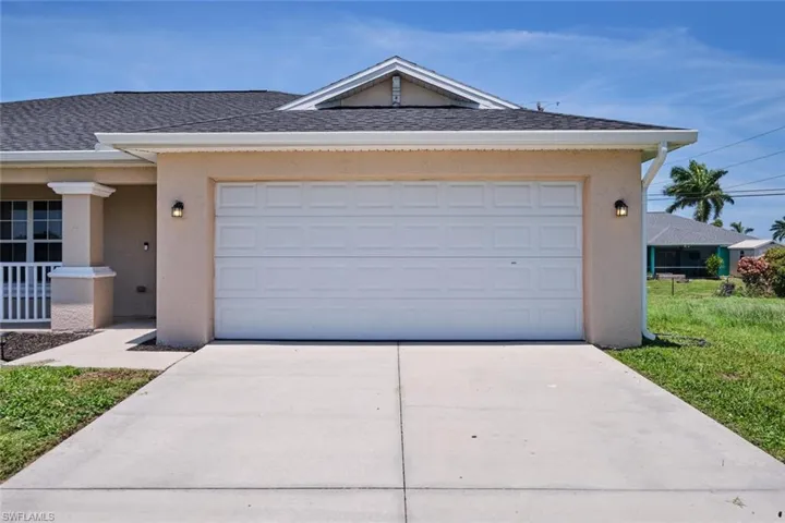 View of front of house with a front yard and a garage