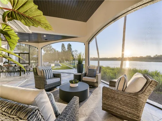 Sunroom / solarium with a water view and wooden ceiling
