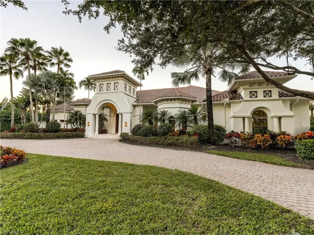 Mediterranean / spanish home with a front yard and stucco siding