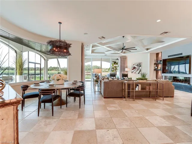 Dining room featuring coffered ceiling, a chandelier, a ceiling fan, and beamed ceiling