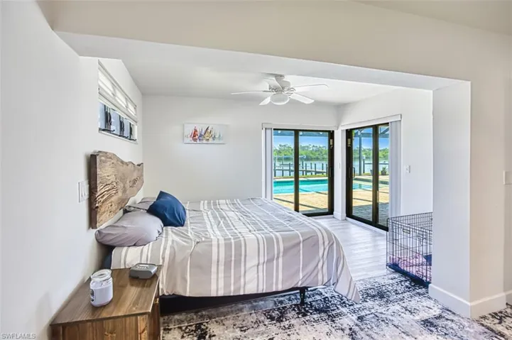 Master bedroom with sliders to the lanai and pool area.  Wake up to the sun beaming on the river!