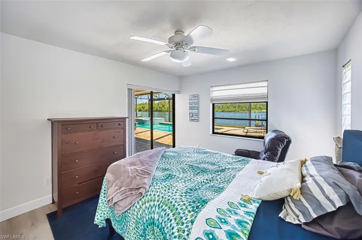 Guest bedroom with sliders to lanai overlooking the river.