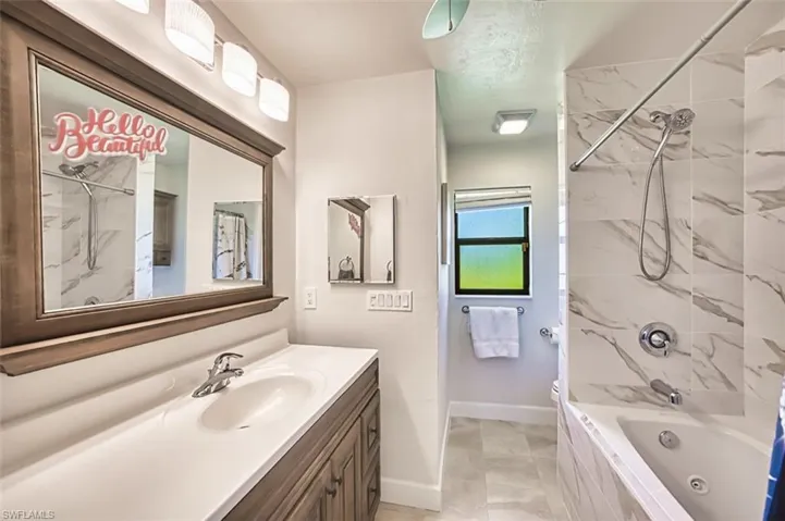Bathroom with vanity,  bathing tub / shower combination, His and Her private baths off primary bedroom