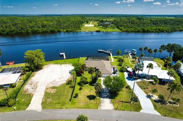Aerial view of a nearby body of water and a wooded area