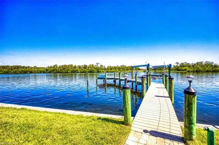 Dock area featuring boat lift and a water view, gulf access